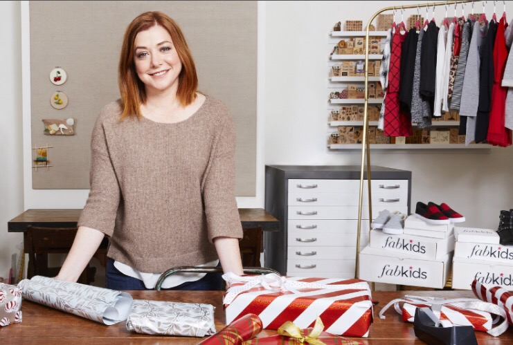Alyson Hannigan and family graciously turned their home into Santa's workshop to package FabKids shirts, pants, dresses, hats, and accessories to donate to children through Corazon de Vida. (PRNewsFoto/FabKids)